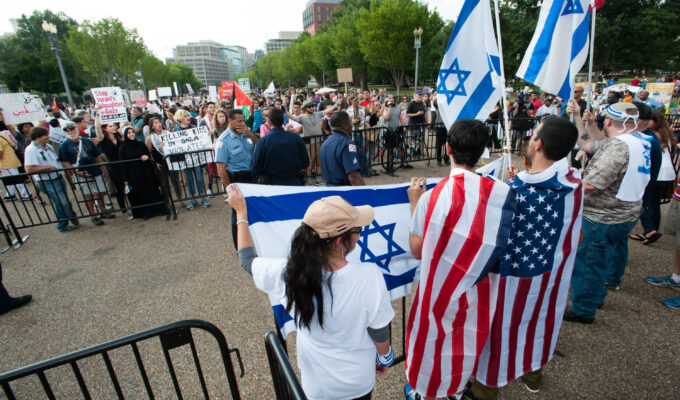 Protest against Israeli attacks on Gaza, Washington, DC, 9.8.2014 Photographer: Ryan Rodrick Beiler 09 Aug 2014 29761 Activists protesting Israel's attacks on Gaza are separated from a handfull of pro-Israel counter-protesters by steel police barriers during a demonstration in front of the White House in Washington, DC, August 9, 2014. The protest was part of a global 