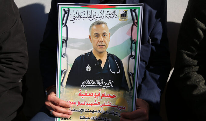 Protest for Dr. Hussam Abu Safiya , Hebron, 9.1.2025 Photographer: Mosab Shawer 09 Jan 2025 55361 A sit-in protest is held in Hebron, West Bank, in front of the headquarters of the International Red Cross Committee, opposing the arrest of Dr. Hussam Abu Safiya and the targeting of medical personnel in the Gaza Strip amid the ongoing genocide, January 9, 2025. Protesters, with among them health workers, display signs calling for his release, and hold posters stating: 